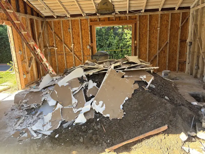 Demolition debris inside the stripped garden room
