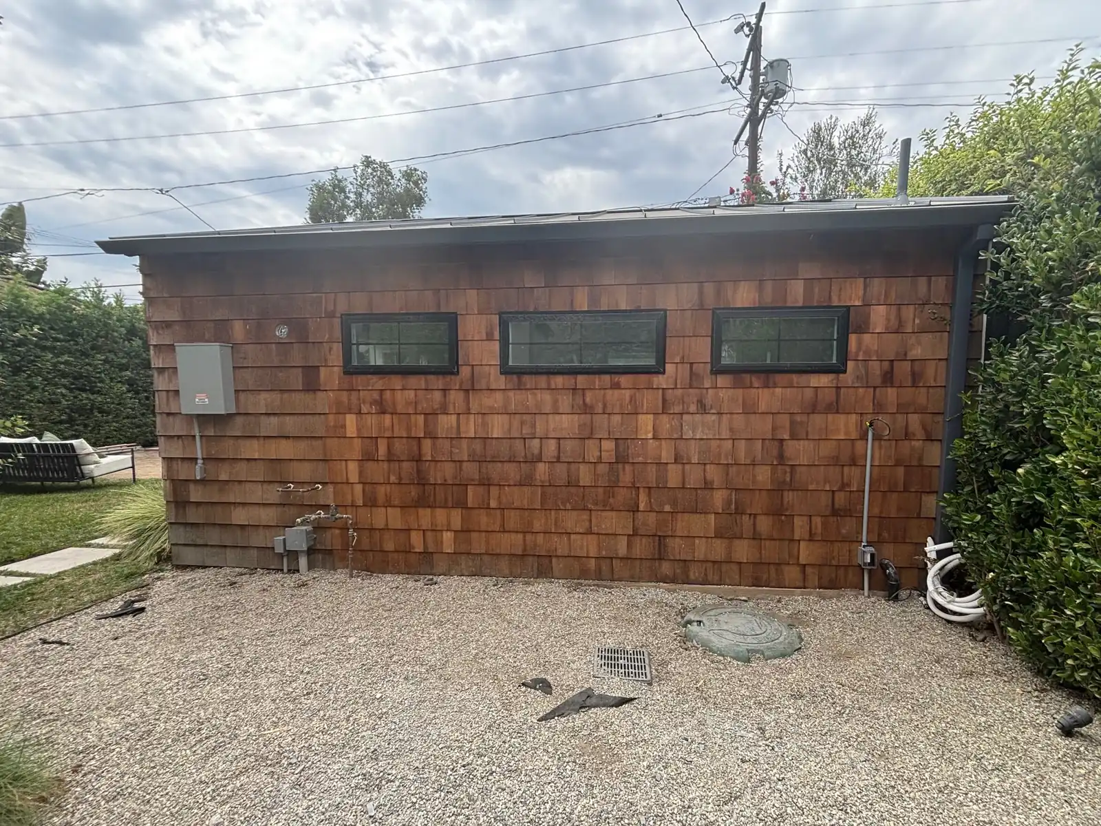 The finished wall in cedar shingle with three clerestory windows