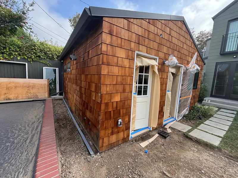 New cedar shingles going up around the doors