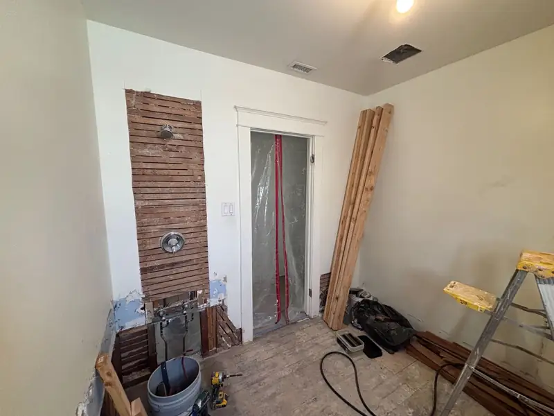 The bath during demolition, plaster stripped to the old lath