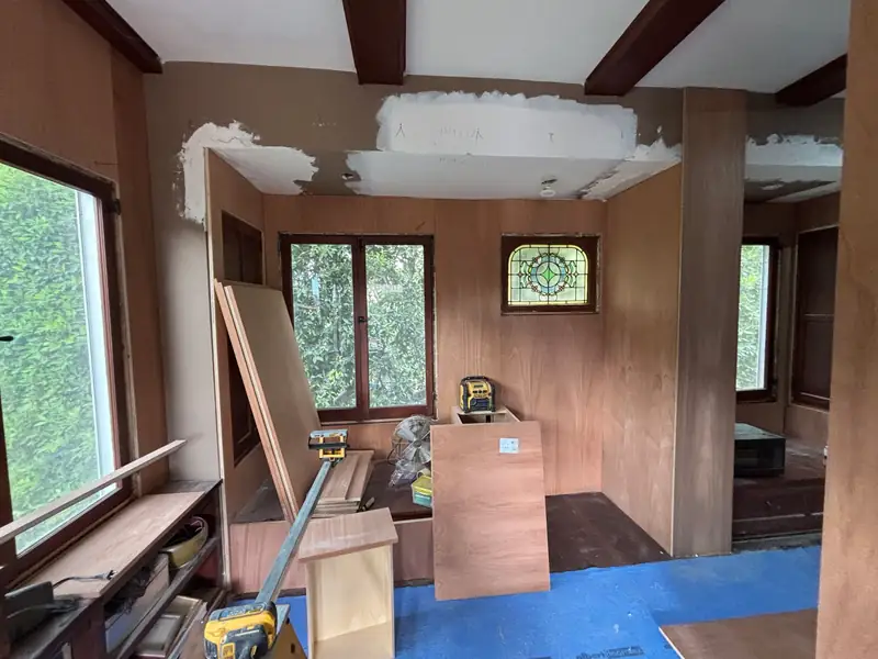 Paneling and soffits coming out, with materials staged on the floor