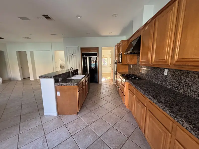 The original galley run with dark granite and a tile backsplash
