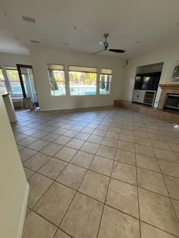 The living room before the remodel, with tile floors and a plain fireplace