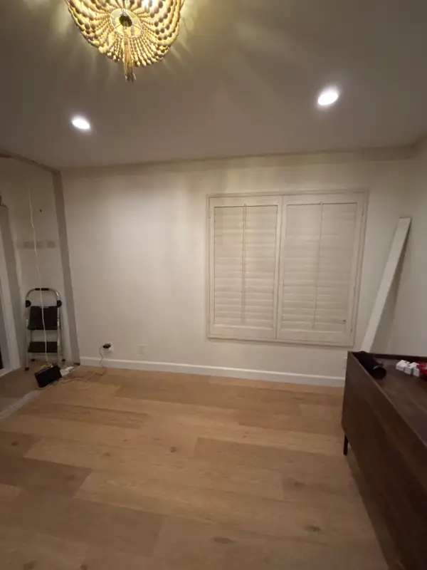 The emptied room with new oak flooring down and walls ready for plaster