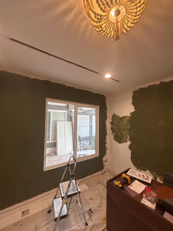 First coats of olive Venetian plaster going on around the window