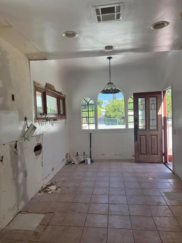 The old kitchen with tile floors and patched walls before demolition