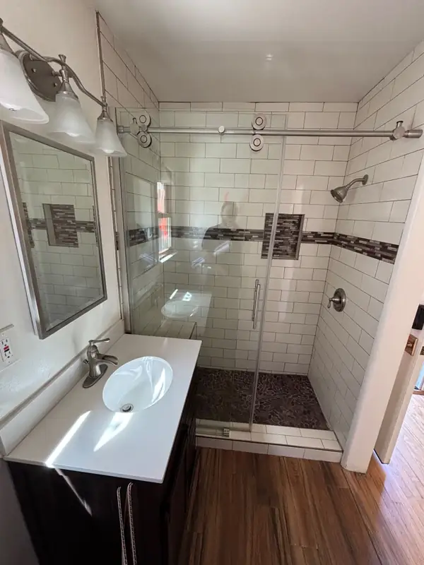 The original bath with white subway tile and a basic vanity