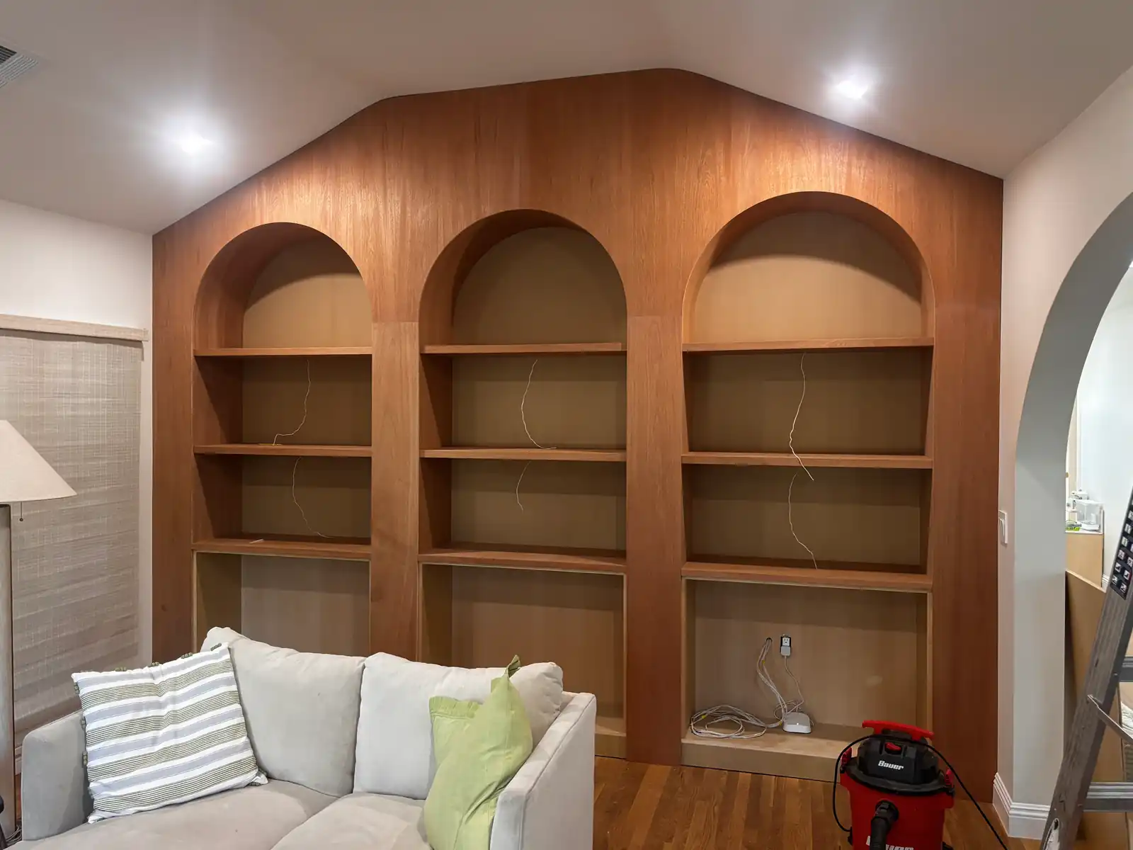 The finished cherry built-in wall on install day, with the room still in use