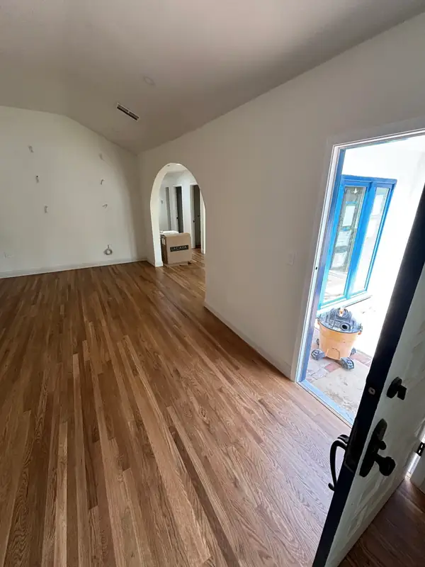 Arched opening and new cobalt-painted doors, floors refinished