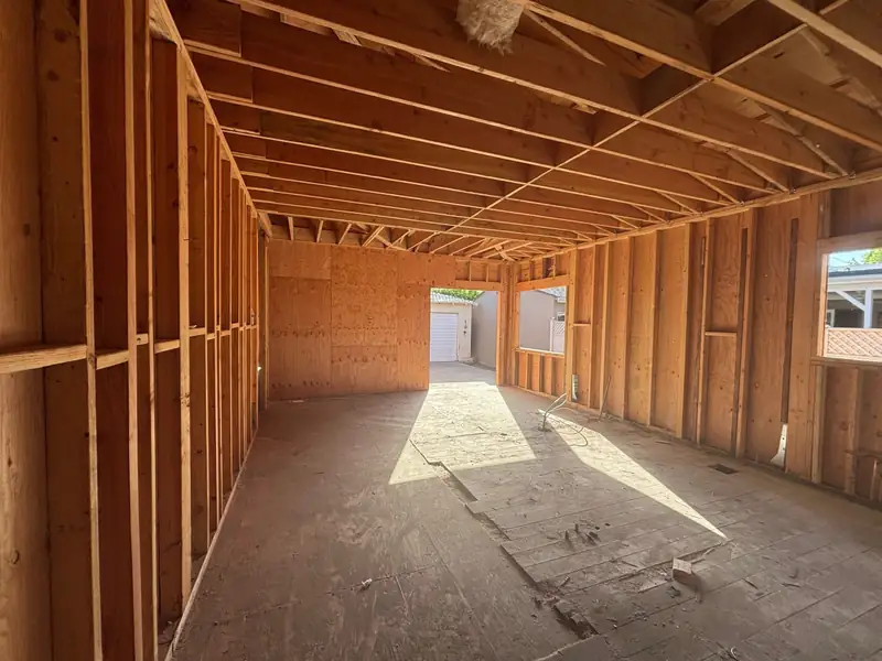 Long framed corridor with ceiling joists overhead