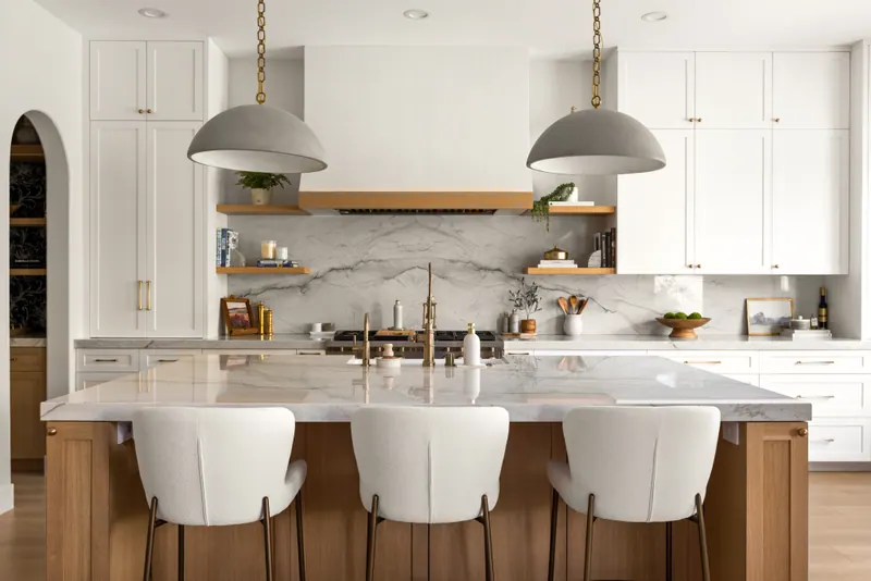 Symmetrical kitchen with paired pendants and a centered range