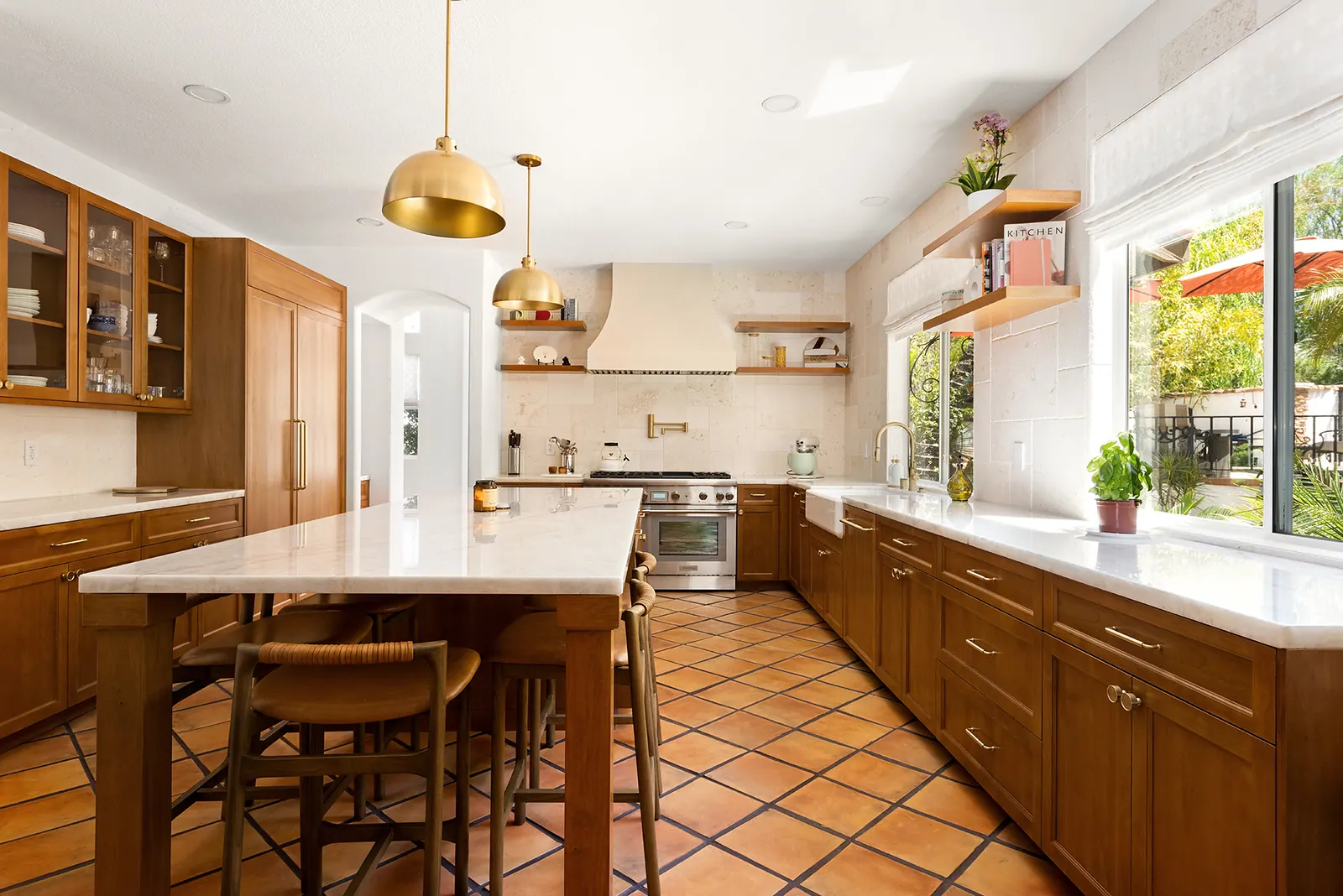 Galley view of the kitchen with wood shaker cabinets and a window over the counter