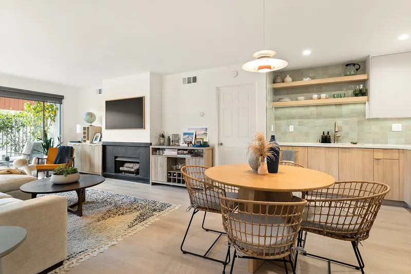 Open-plan living and dining room with the kitchen along the back wall